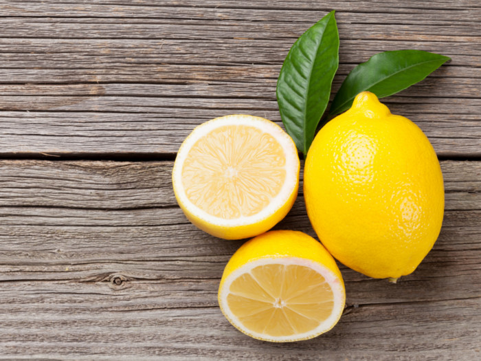 Fresh lemon and leaves on a wooden table